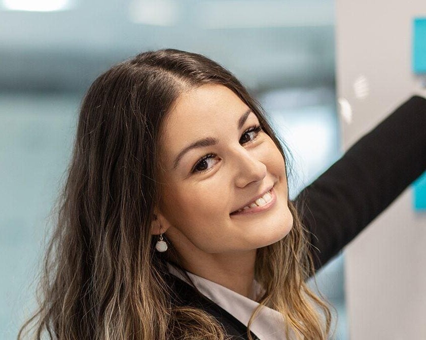 Smiling professional woman reflecting the traits of good leadership