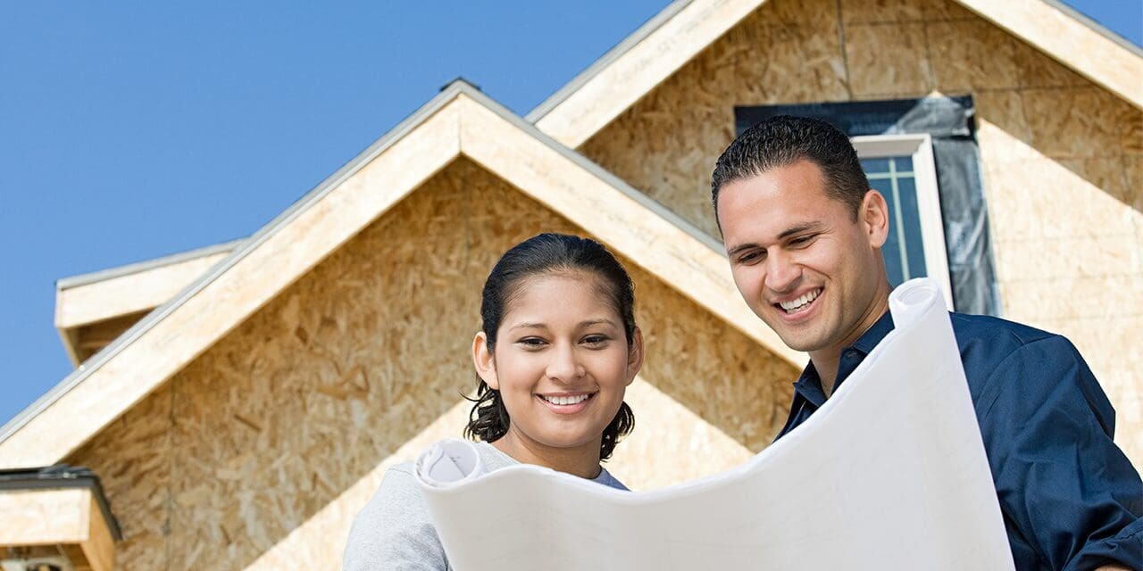 A couple is looking at plans for a house and how to build a stronger marriage