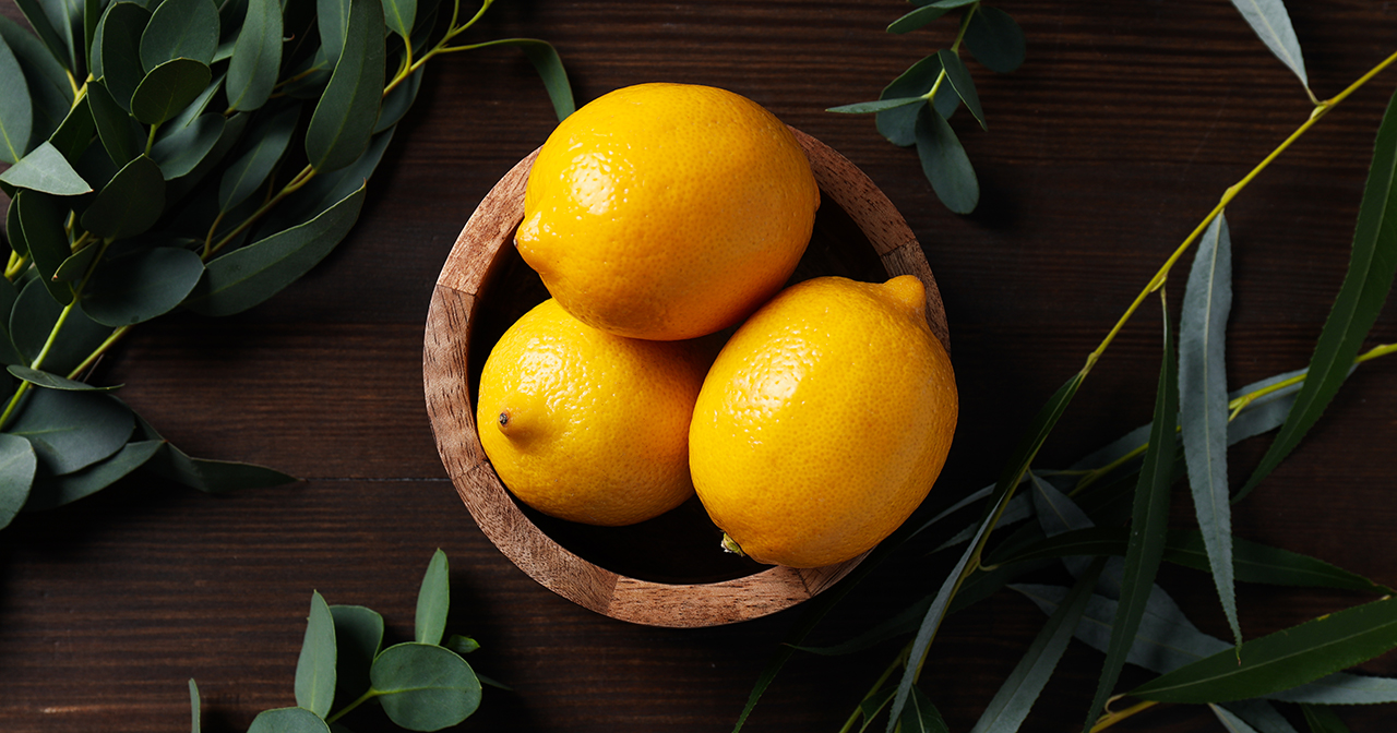 Bright yellow lemons in a wooden dish, showing something good and happy that's blossomed from a seed.
