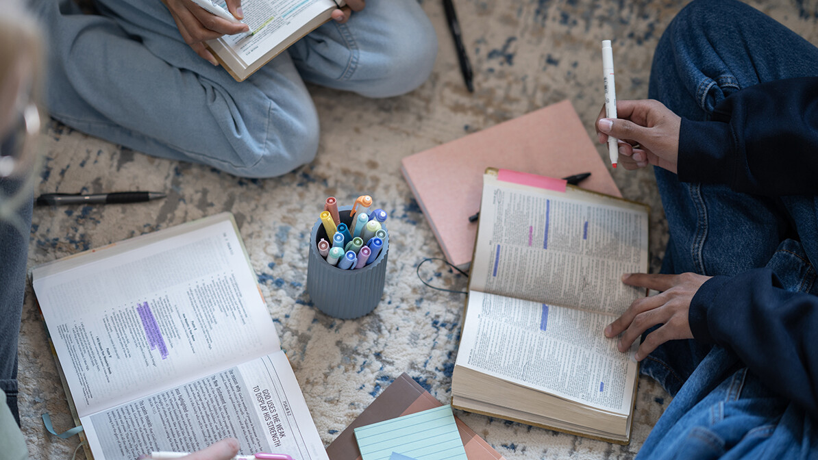 group of females studying the Bible and taking notes and highlighting the Bible, decree and declare
