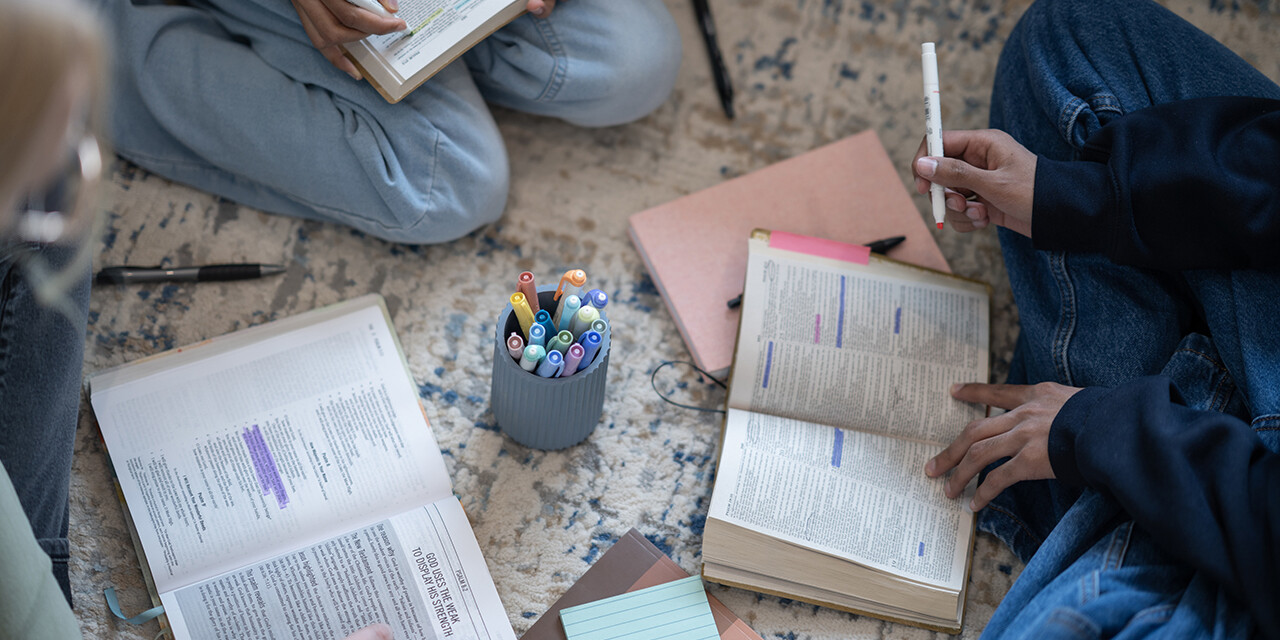 group of females studying the Bible and taking notes and highlighting the Bible, decree and declare