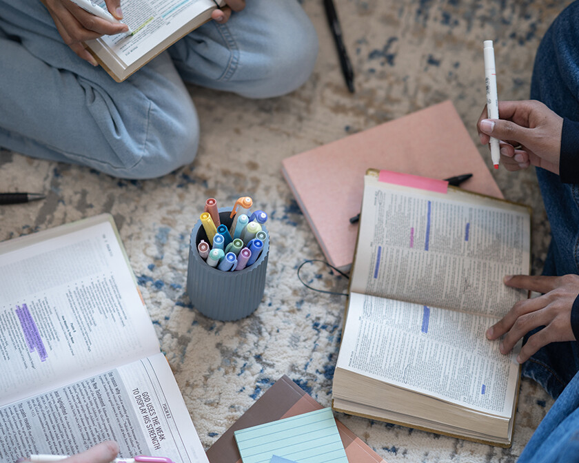 group of females studying the Bible and taking notes and highlighting the Bible, decree and declare