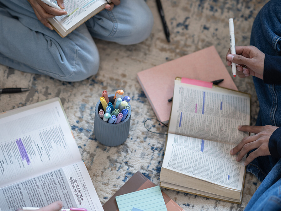 group of females studying the Bible and taking notes and highlighting the Bible, decree and declare