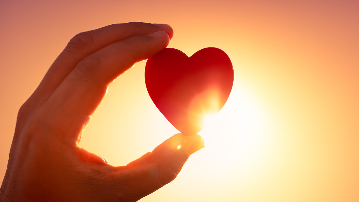 Hand holding a heart at sunset, Afshin's testimony from Islam to Christianity