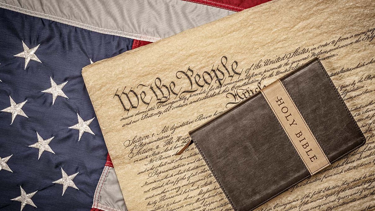 American flag with Constitution and Bible