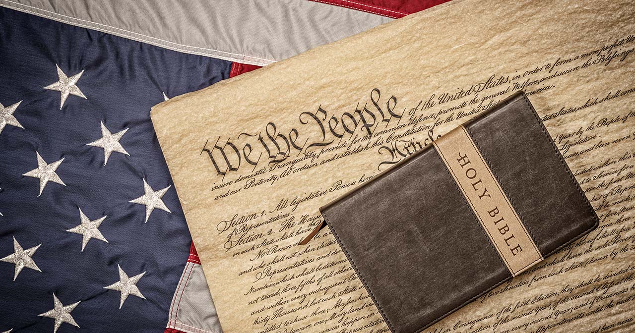 American flag with Constitution and Bible