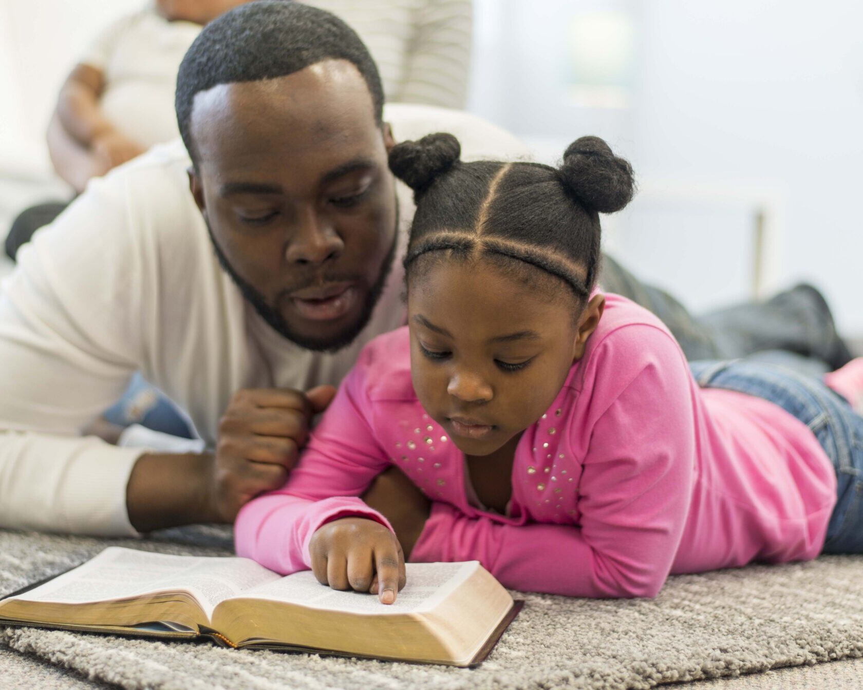 father reading the Bible with his daughter, father's day devotional