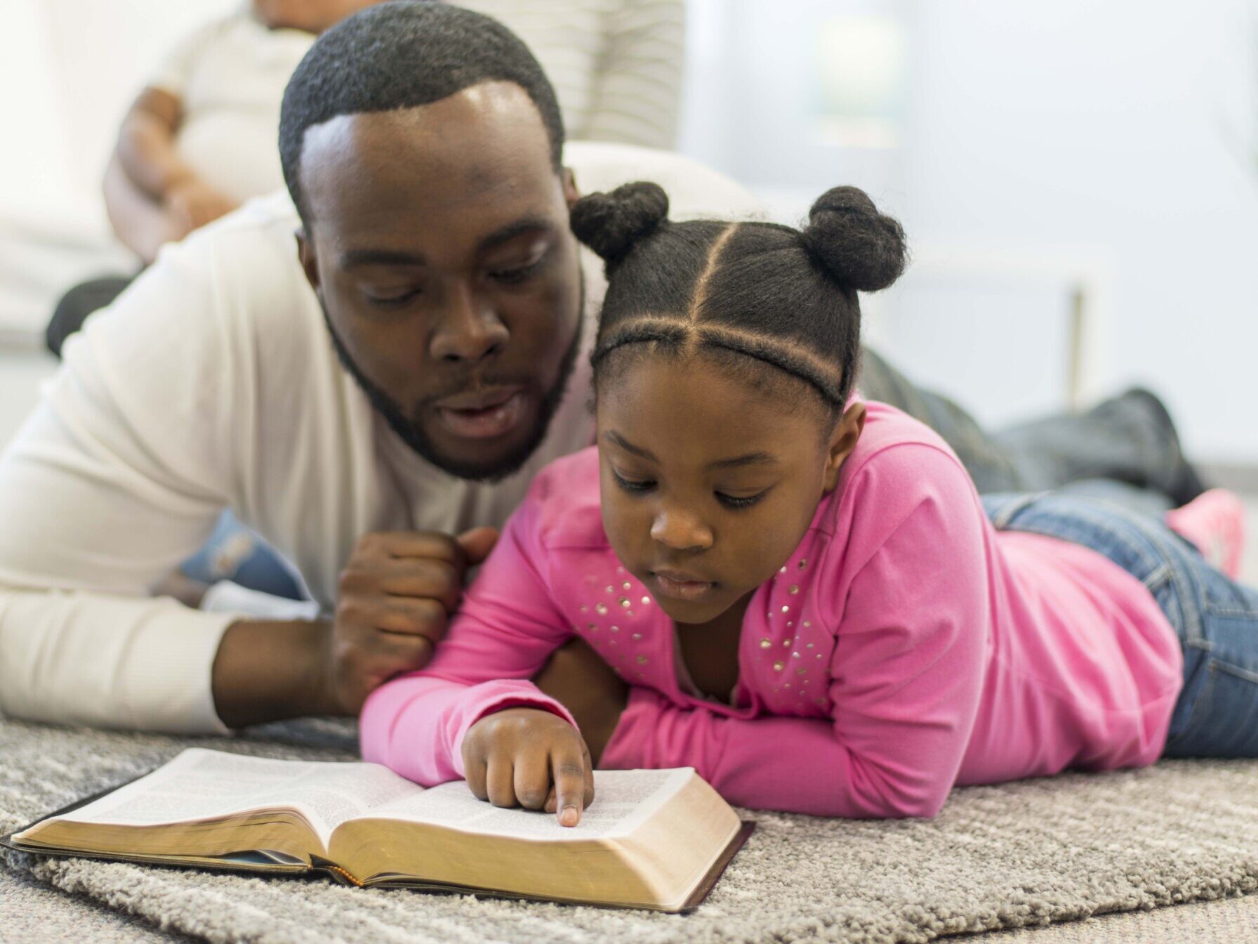 father reading the Bible with his daughter, father's day devotional