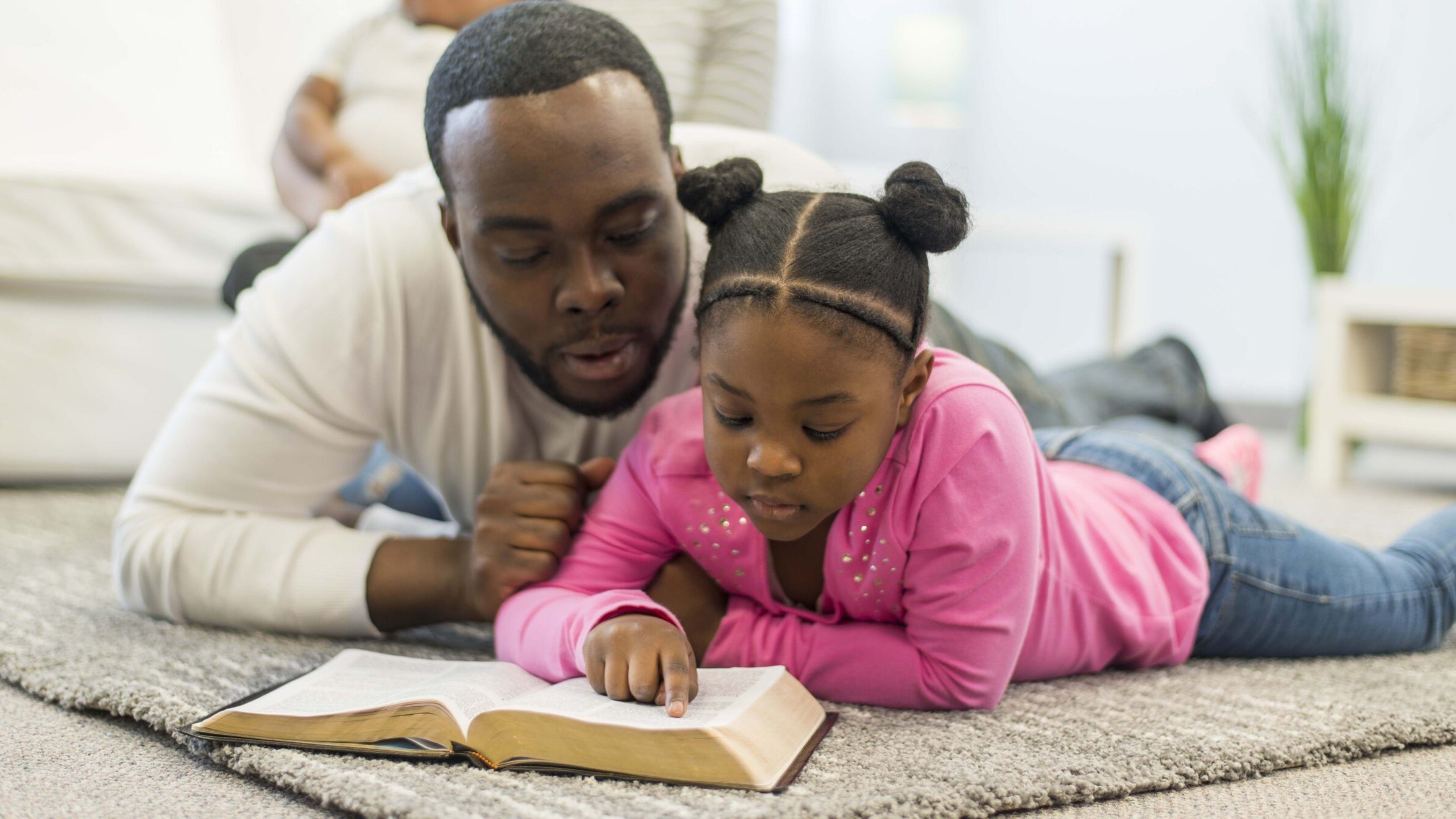 father reading the Bible with his daughter, father's day devotional