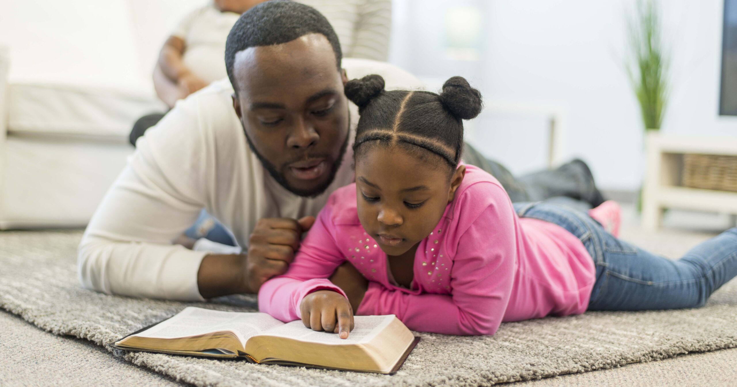 father reading the Bible with his daughter, father's day devotional