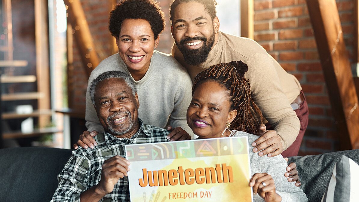 Juneteenth, family of four holding Juneteenth sign