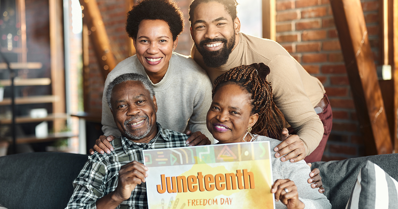 Juneteenth, family of four holding Juneteenth sign