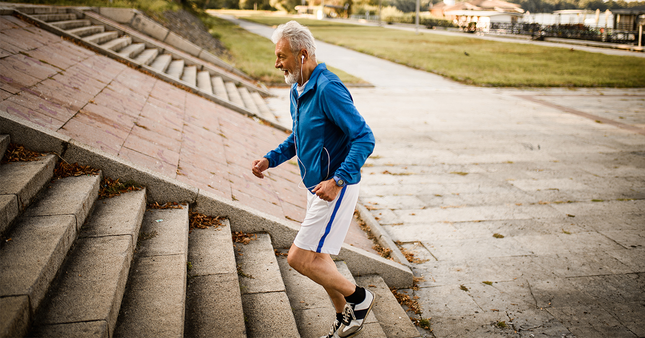 Man running up a flight of outdoor stairs.