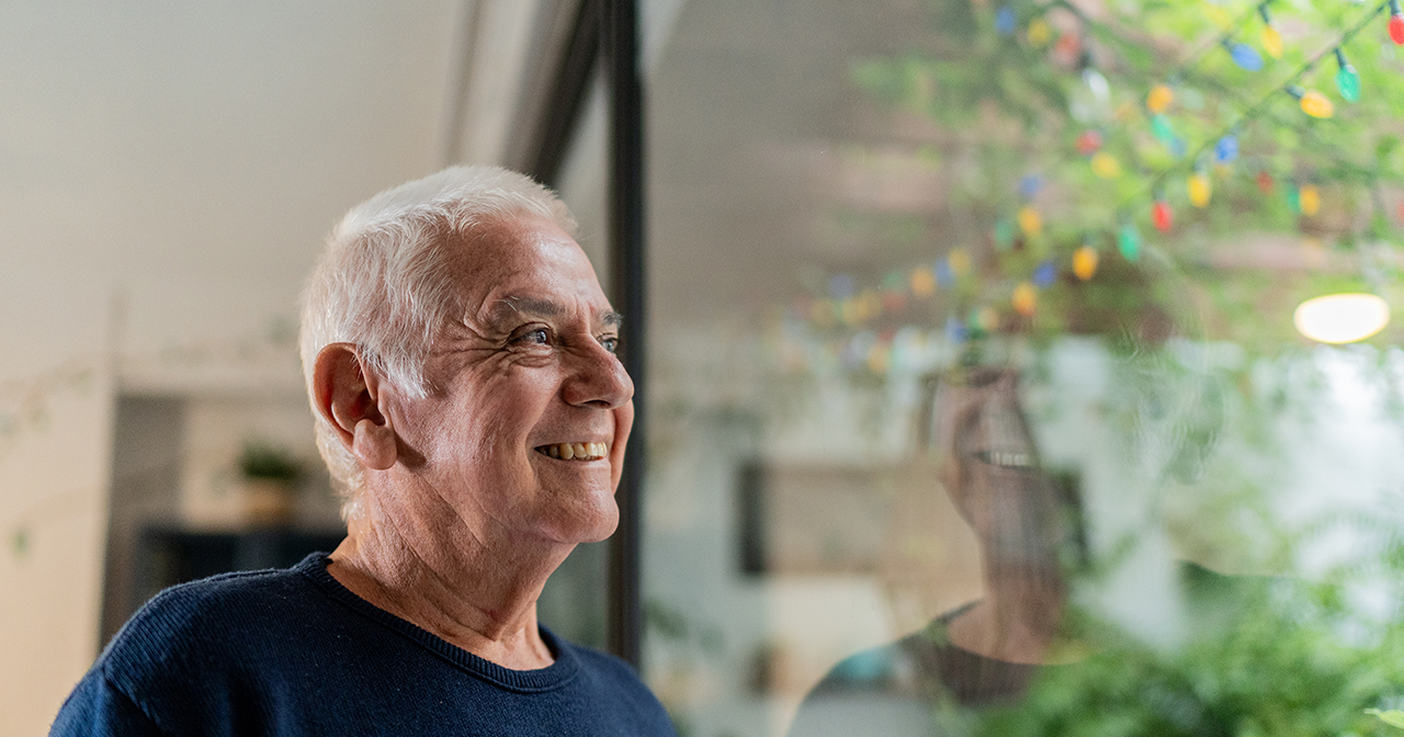 Man looking out his window at the natural scenery.