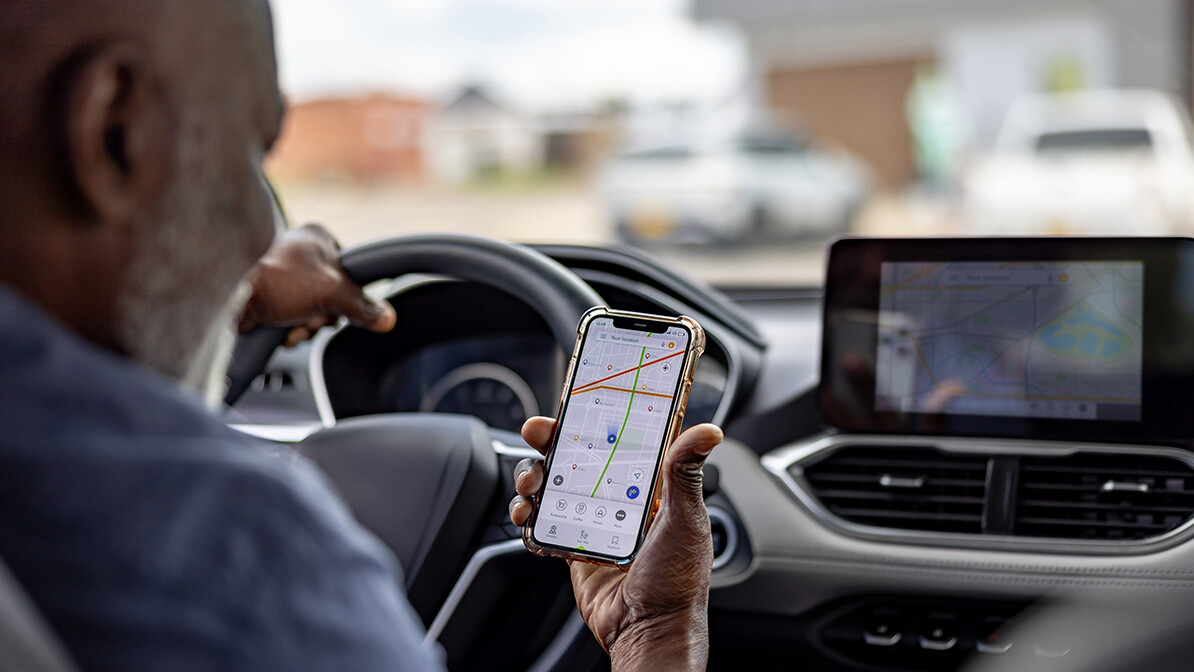 Man using GPS navigation while driving a car.